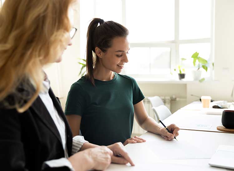 a holistic health therapist reviewing forms during an initial session